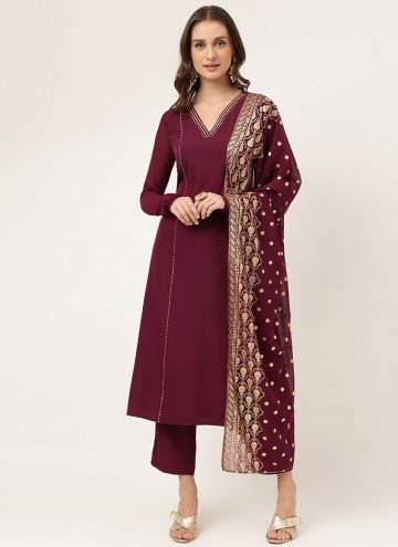 Faux Crepe Salwar Suit in Maroon Enhanced with Pla