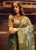 Handloom Silk Trendy Saree in Green Enhanced with Woven - 1