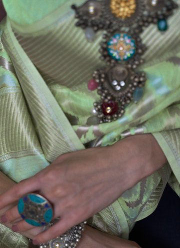 Patola Silk Classic Designer Saree in Green Enhanced with Hand Work